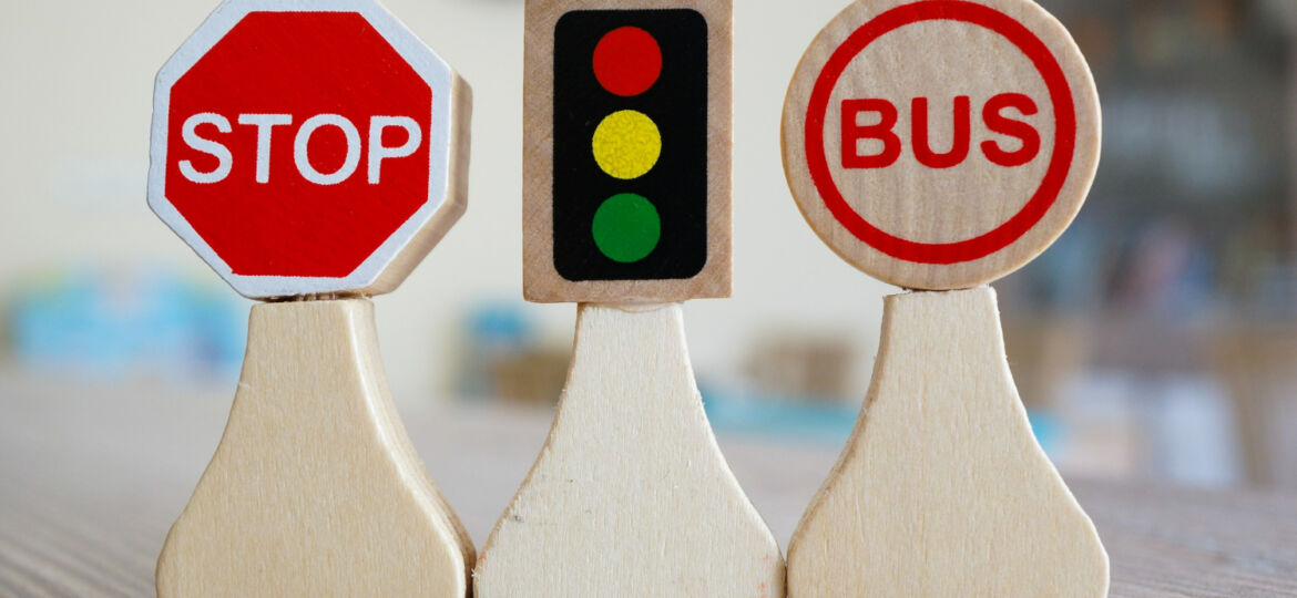 closeup-shot-of-miniature-wooden-road-signs-on-table